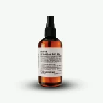 A 60ml amber bottle of Klarif Captor Dry Oil for skin, body and hair
